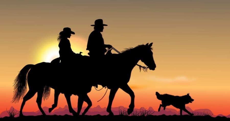 dog running in front of horses, cowboys